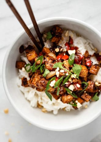 a bowl of kung pao tofu topped with green onions