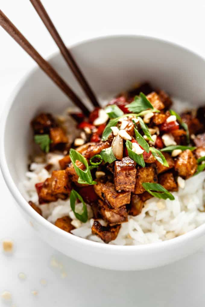 Kung pao tofu on rice in a white bowl