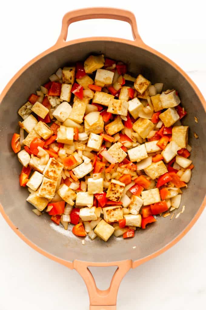 tofu, red peppers and onions sauteéd in a pink pan
