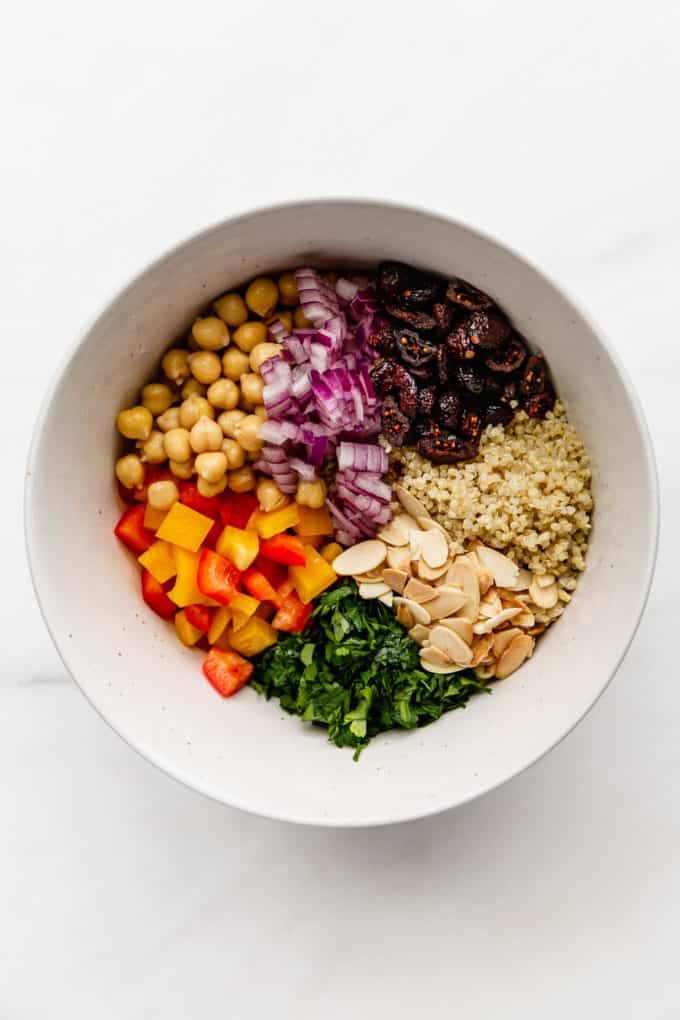 a bowl with quinoa, vegetables and chickpeas in it