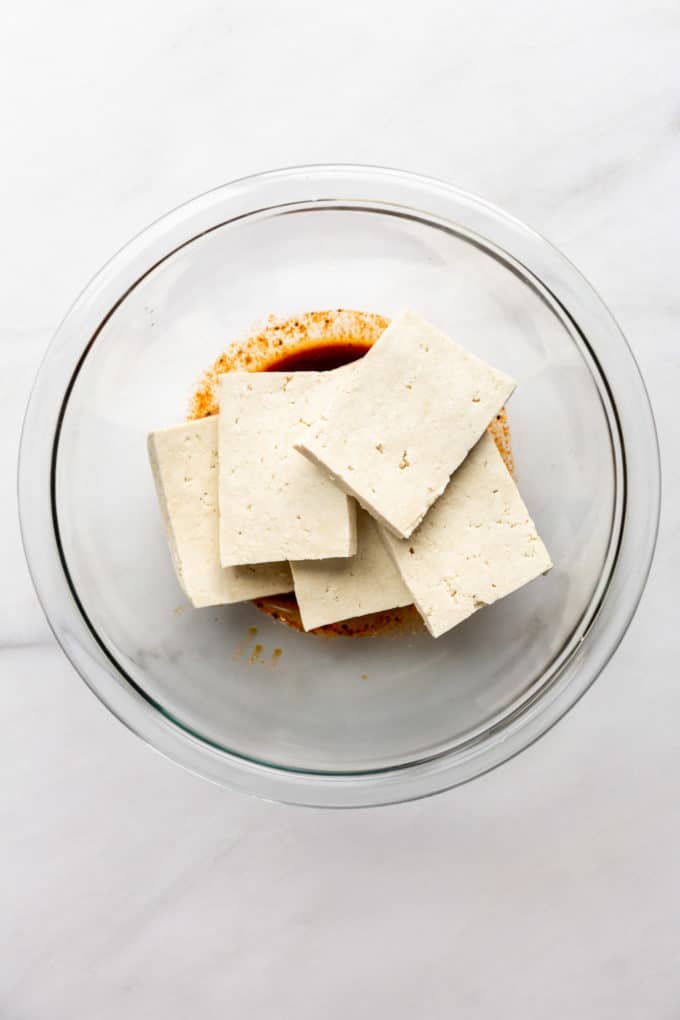 slices of tofu in a clear bowl
