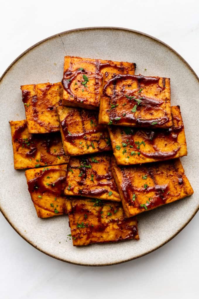 A plate of barbecue tofu cut into squares