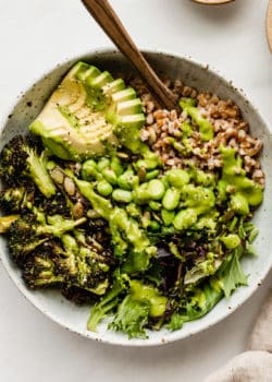 A green goddess bowl topped with green goddess dressing