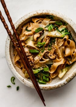 ho fun noodles in a bowl with wood chop sticks