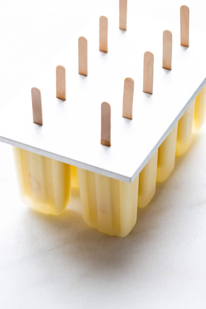 pina colada popsicles in a popsicle mould
