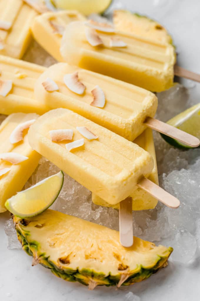 a close up of pina colada popsicles on ice