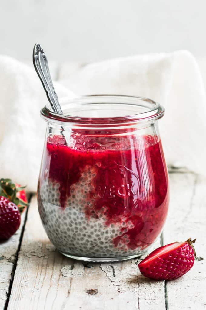 a jar of chia pudding with strawberry rhubarb compote