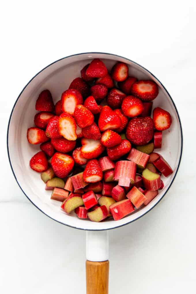 strawberries and rhubarb in a white pot