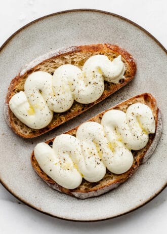 whipped ricotta with olive oil and pepper on two slices of toast