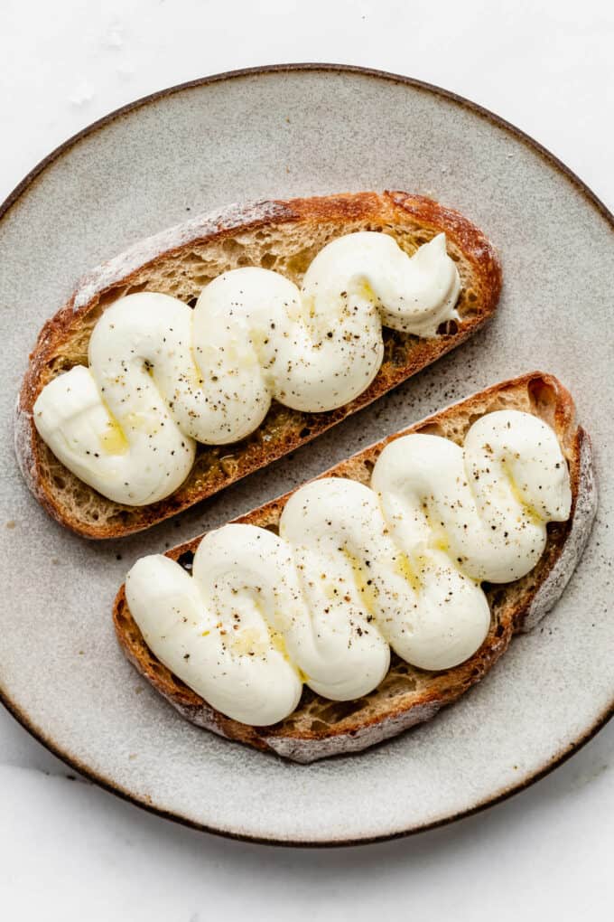 whipped ricotta with olive oil and pepper on two slices of toast