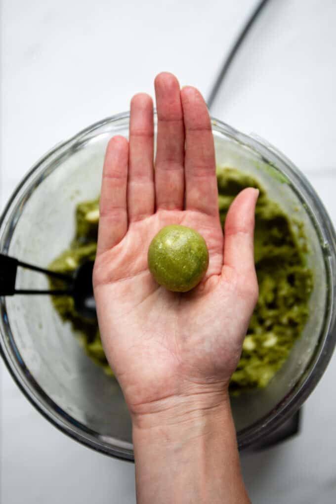 a matcha energy ball in a hand