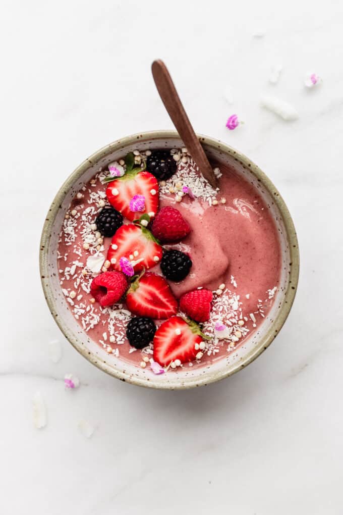 strawberry smoothie bowl topped with fresh berries