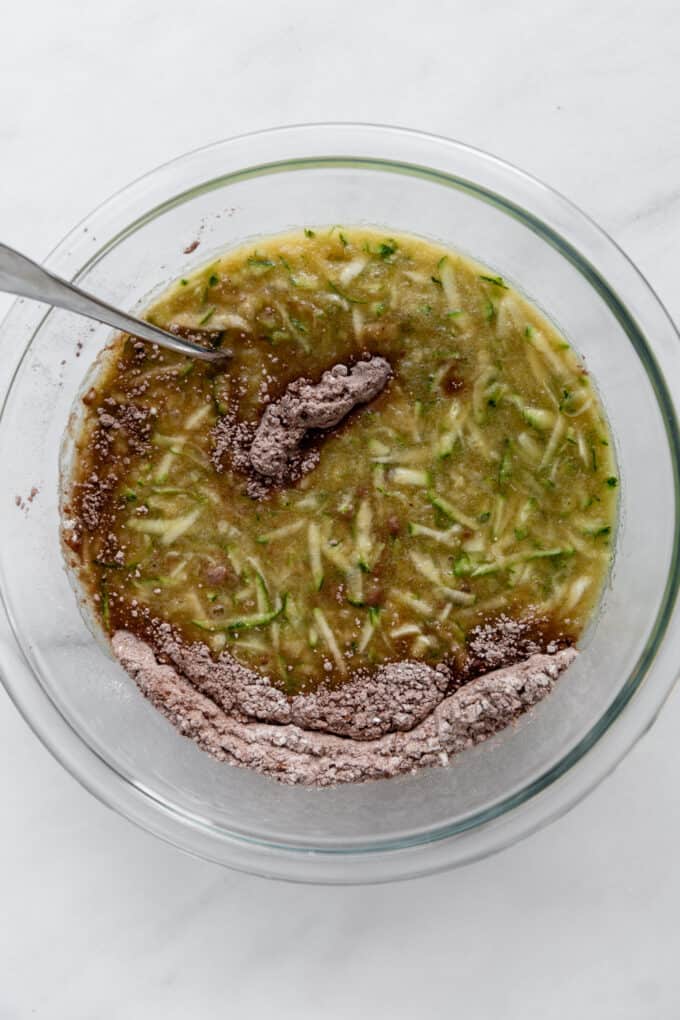 zucchini, eggs and flour in a mixing bowl
