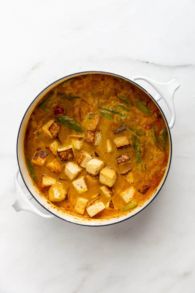 tofu and vegetables in a pot of massaman curry sauce