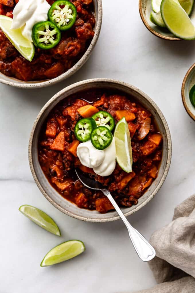 two bowl of sweet potato chili topped with sour cream