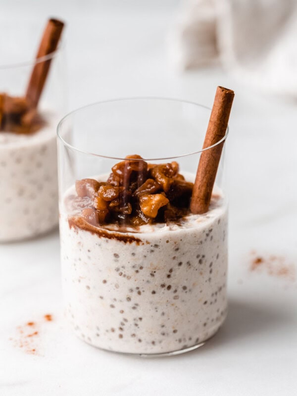 a cup of apple overnight oats topped with stewed apples