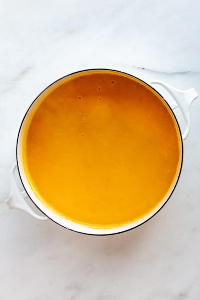 a pot of butternut squash soup with apple