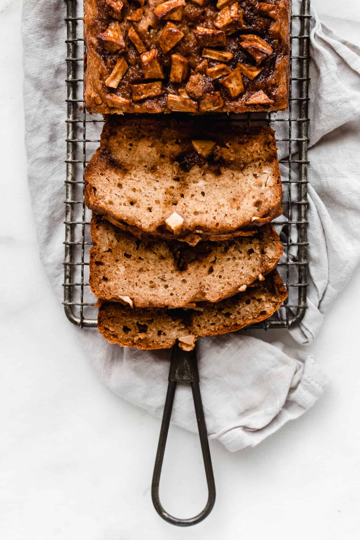 3 slices of cinnamon apple bread on a cooling rack
