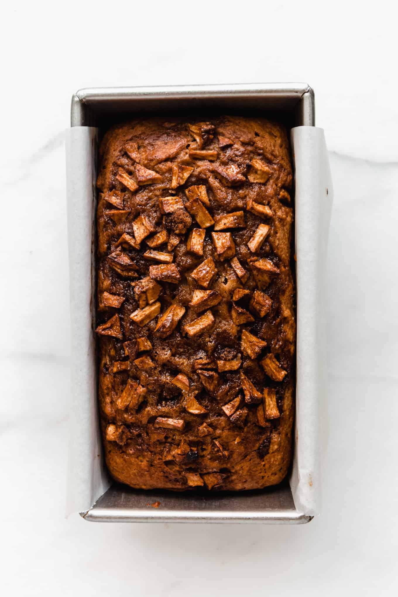 cinnamon apple bread in a loaf pan
