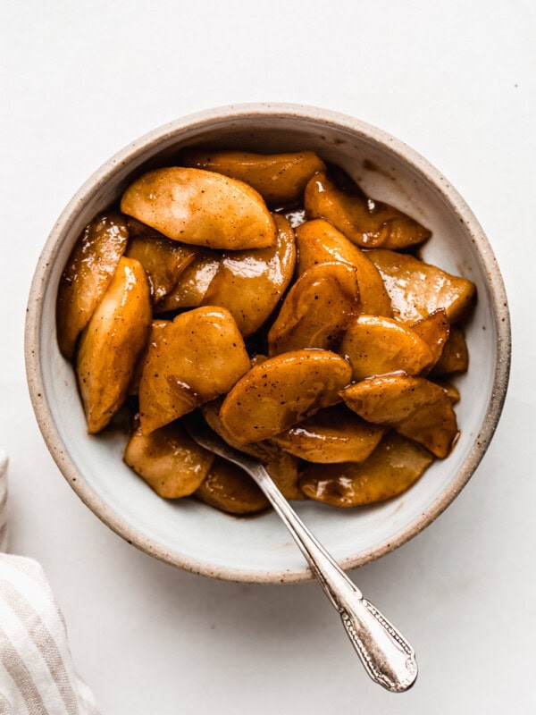 cinnamon apples in a small bowl with a spoon