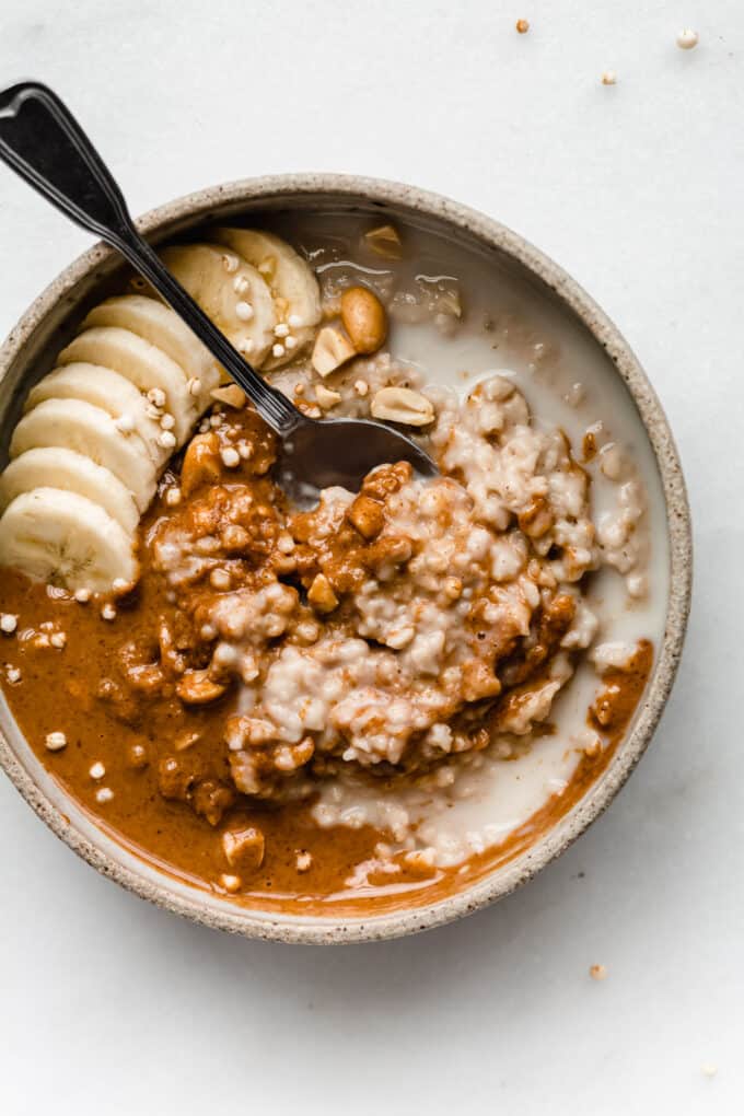 a bowl of peanut butter oatmeal with bananas on top