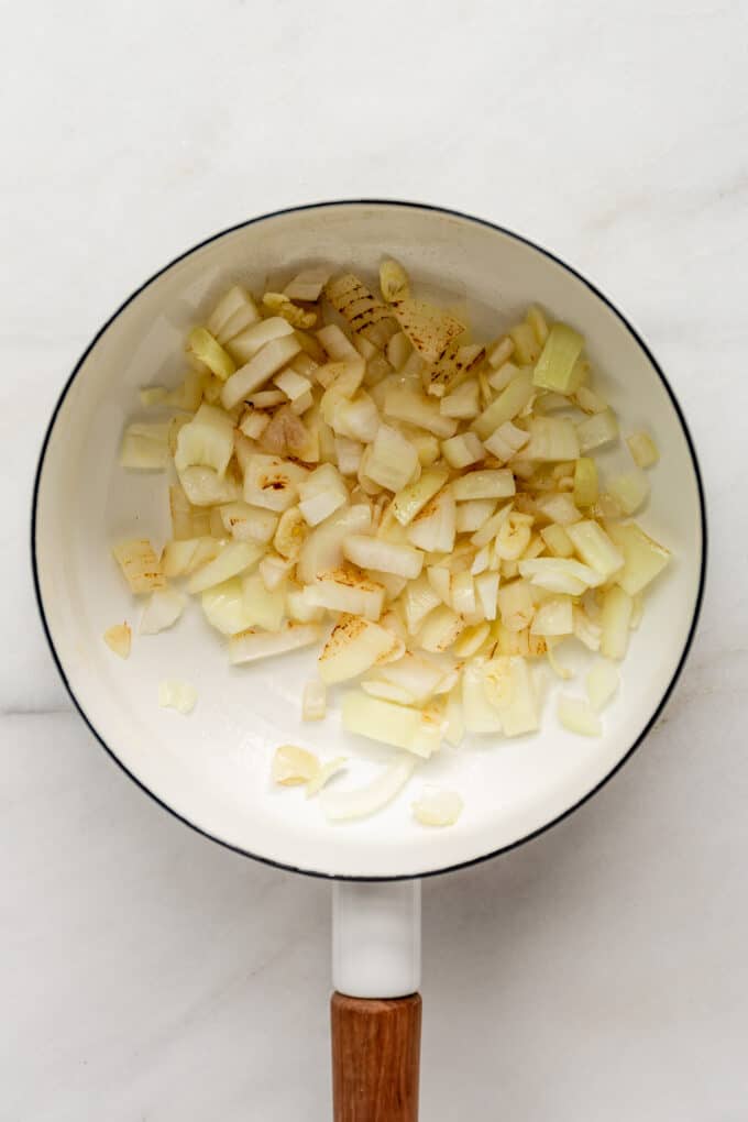 onions and garlic in a white pot