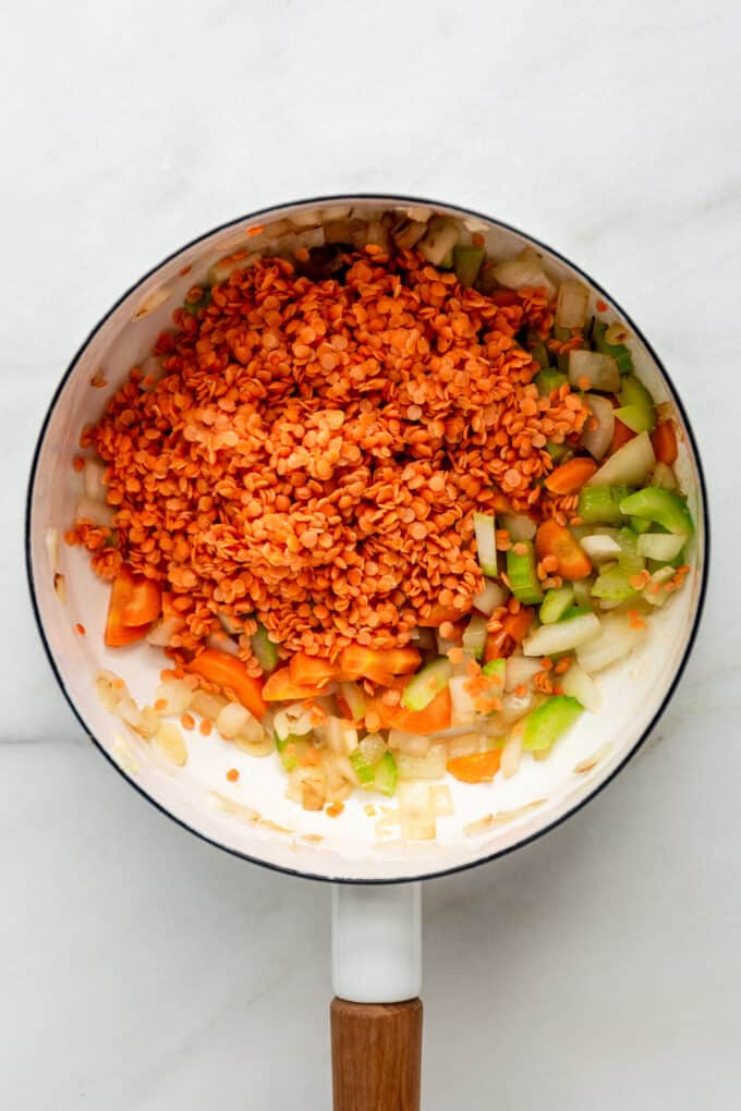 red lentils and vegetables in a white pot