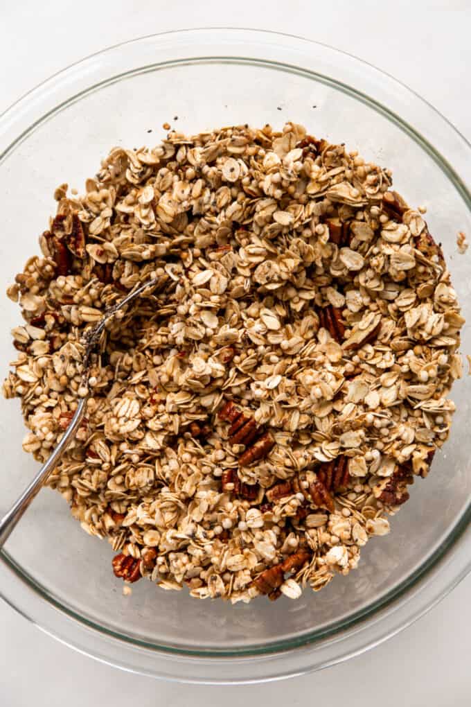 maple pecan granola mixed in a clear mixing bowl