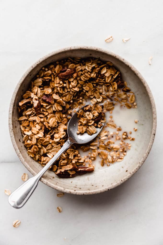 A bowl of maple pecan granola with almond milk
