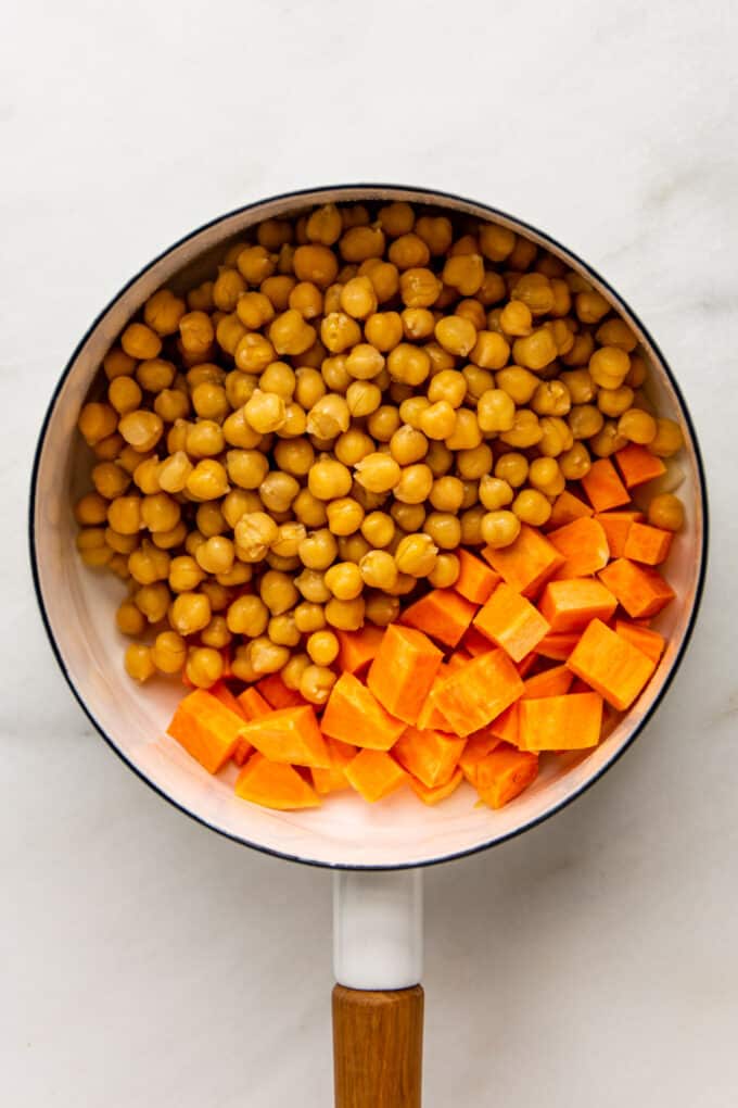 chickpeas and sweet potatoes in a white pot