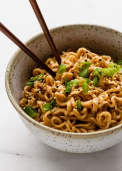 peanut ramen noodles in a bowl with green onions