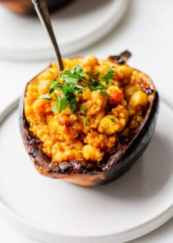 a stuffed acorn squash topped with parsley
