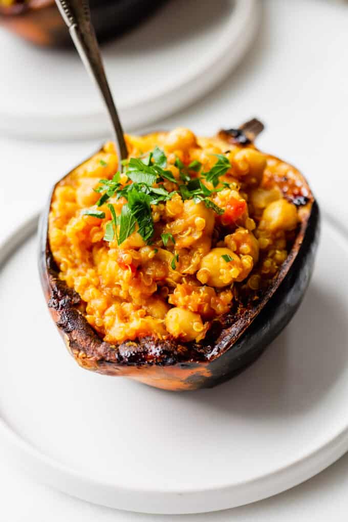 a stuffed acorn squash topped with parsley