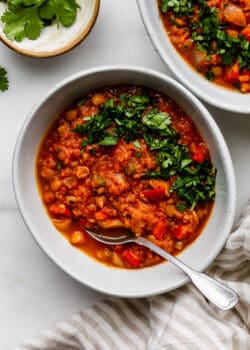 a bowl of lentil chili with cilantro on top