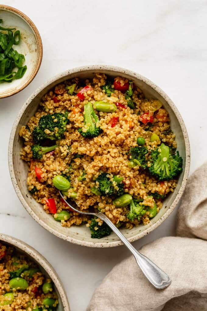 Quinoa fried rice with vegetable in a bowl with a spoon
