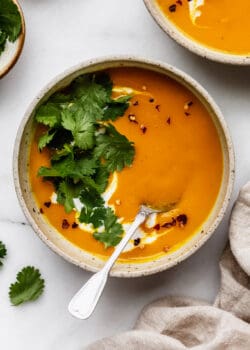 butternut squash sweet potato soup topped with cilantro and chili flakes
