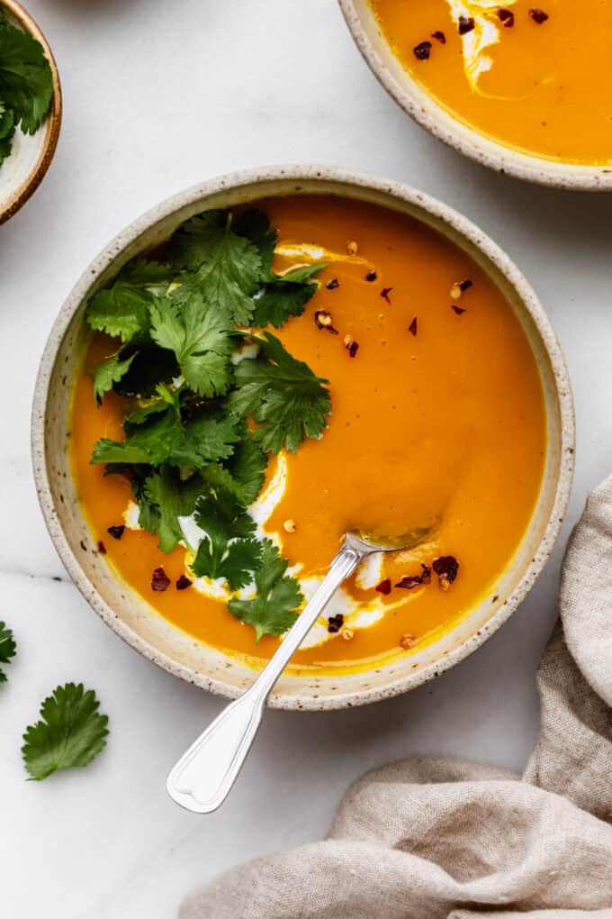 butternut squash sweet potato soup topped with cilantro and chili flakes