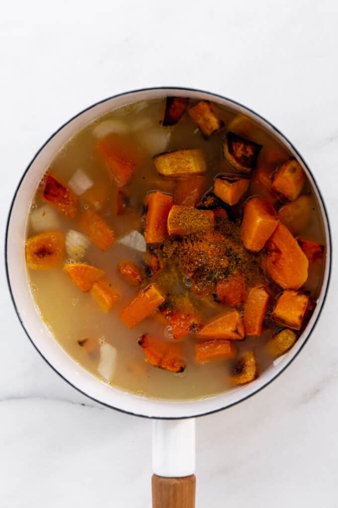 squash, sweet potato and broth in a white pot