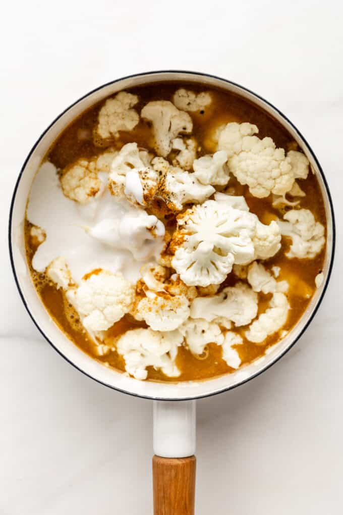 cauliflower, broth and coconut milk in a pot