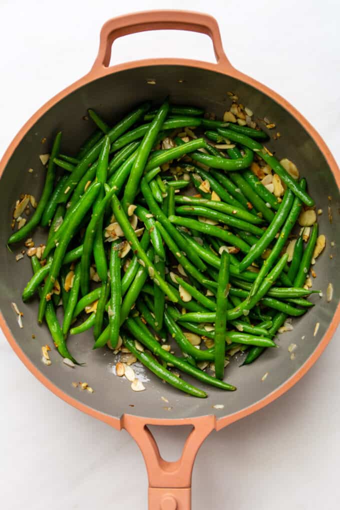 green beans almondine in a pink pan