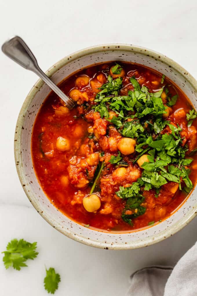Moroccan chickpea stew in a white speckled bowl