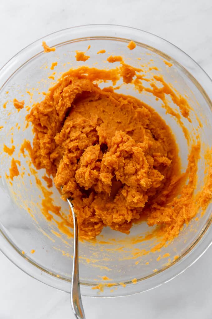 mashed sweet potatoes in a clear mixing bowl