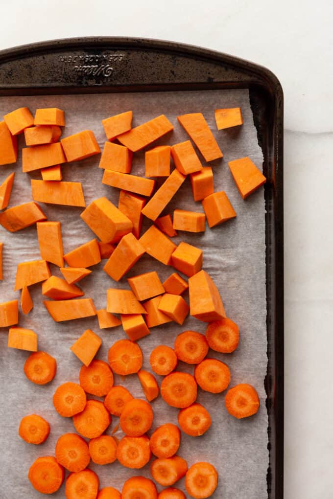 cut up sweet potato and carrots on a pan