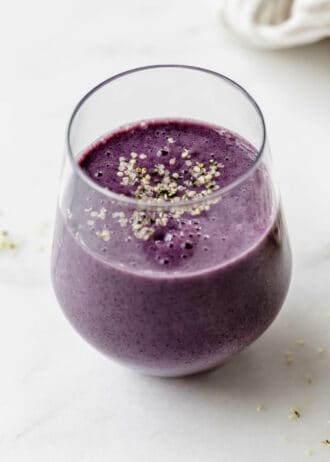 A blueberry avocado smoothie topped with hemp seeds