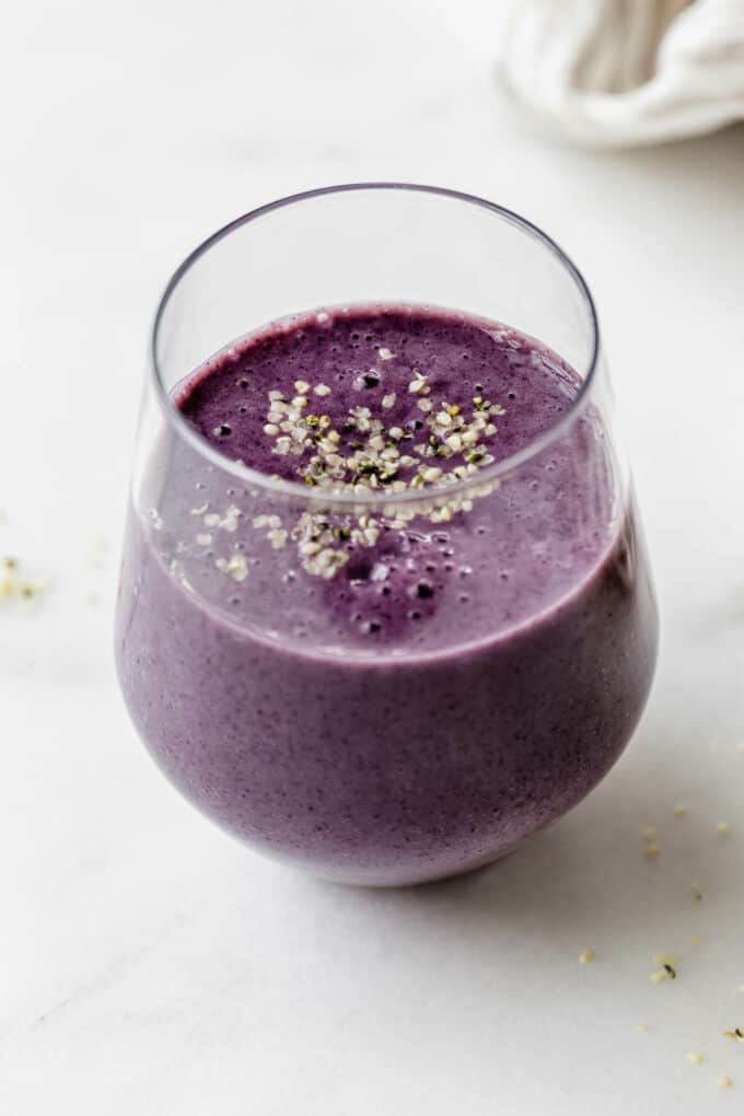 A blueberry avocado smoothie topped with hemp seeds