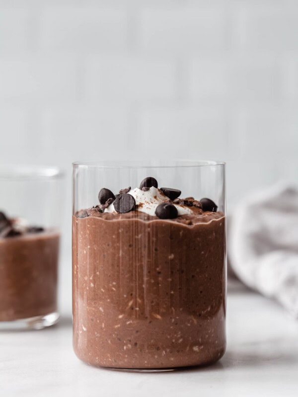 a cup of overnight oats topped with chocolate chips