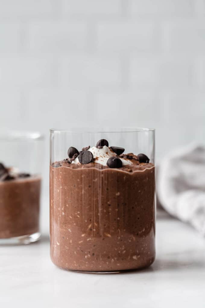 a cup of overnight oats topped with chocolate chips