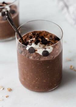 a cup of chocolate overnight oats with a spoon in it