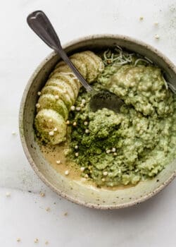 matcha oatmeal in a bowl topped with bananas and matcha powder