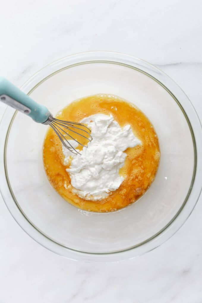 eggs and cottage cheese in a mixing bowl with a whisk